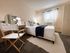 Inviting bedroom with cozy bed, stylish decor, and large window providing natural light.