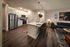 Flats at Walnut Ridge Apartments - Modern open-concept kitchen with sleek stainless-steel appliances, inviting island bar, and cozy living area.