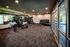 Flats at Walnut Ridge Apartments - Modern fitness center with state-of-the-art equipment, featuring mirrored walls and ample natural light.