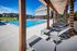 Flats at Walnut Ridge Apartments - Luxurious apartment complex with inviting pool, sun loungers, and modern architecture.
