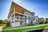Flats at Walnut Ridge Apartments - Elegant modern apartment complex featuring spacious balconies, lush green surroundings, and stylish architectural design.