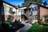 Shore Acres Apartments in Indianapolis, IN - Charming brick apartment exterior with lush landscaping and modern stairway access.