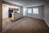 Shore Acres Apartments in Indianapolis, IN - Modern open-concept living room with sleek kitchen and natural light, ideal for stylish urban living.