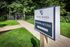 Shore Acres Apartments in Indianapolis, IN - Inviting outdoor pathway leading to Shore Acres Apartments with lush greenery and gated Monon access.