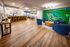 Shore Acres Apartments in Indianapolis, IN - Elegant communal area with modern bar seating and chic lounge chairs, featuring vibrant wall art creating a lively ambiance.