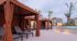 Elegant poolside area with cozy cabanas and lounge chairs near a serene swimming pool surrounded by modern apartments.
