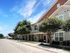 Beautiful townhouse exterior with modern architecture and lush landscaping under a bright blue sky.