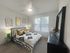 Sophisticated bedroom with modern decor, featuring a king-sized bed, stylish artwork, and large window.