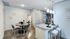 Modern open-plan kitchen and dining area with sleek countertops, stylish bar stools, and elegant lighting.