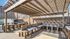 Charming outdoor patio with cozy seating under a stylish pergola, perfect for gatherings and relaxation.