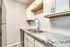 Modern kitchen with sleek stainless steel appliances and elegant granite countertops.