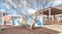 Inviting exterior view of Zen Apartments featuring stylish modern design, colorful mural, and welcoming outdoor seating area.