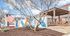 Inviting exterior of Zen Apartments featuring modern architecture, vibrant mural, and a cozy outdoor seating area.