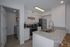 Modern kitchen with sleek granite countertops, stainless steel appliances, and a stylish island with bar seating.