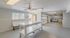 Modern and spacious laundry room featuring efficient washers, ample folding space, and bright natural lighting.