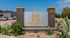 Inviting landscape with a modern sign for The Mirage Apartment Homes, featuring elegant desert flora and a welcoming community vibe.