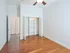 Spacious room with wooden floors, large closet, and ceiling fan, ideal for modern living.