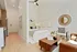 Bright and inviting open-concept apartment showcasing a cozy bedroom with elegant decor, a stylish living space, and a sleek kitchen. Perfect blend of comfort and modern design.