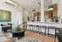 Contemporary open-concept living space with chic decor, featuring a stylish breakfast bar, modern kitchen, and cozy seating area.