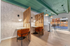 Modern co-working space featuring sleek wooden partitions, cozy chairs, and ample natural light.