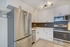 Modern kitchen with sleek stainless steel appliances, elegant white cabinetry, and stylish hexagon tile backsplash creating a contemporary ambiance.