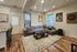 Cozy living room with stylish decor, featuring a plush sectional sofa, modern coffee table, and vibrant artwork, illuminated by soft recessed lighting.