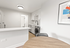 Sleek modern kitchen with stylish cabinetry, integrated appliances, and vibrant artwork. Ideal for contemporary living.