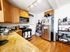 Charming kitchen with warm wooden cabinets, granite countertops, and modern stainless steel appliances. Bright and inviting space ideal for culinary creativity.
