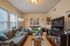 Inviting living room with chic decor, featuring comfortable sofas, elegant wall art, and a sleek entertainment center.