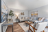 Elegant living room with a cozy gray sectional, stylish wooden furniture, modern decor, and warm ambient lighting.