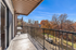 Inviting apartment balcony with a beautiful view of autumn trees and a clear blue sky, perfect for relaxation and enjoying nature.