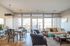 Elegant open-concept living and dining area with abundant natural light, featuring modern furnishings and a cozy atmosphere.