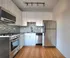 Modern kitchen featuring sleek stainless steel appliances, stylish tile backsplash, and elegant white cabinetry.