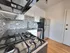 Modern kitchen featuring sleek stainless steel appliances, elegant tile backsplash, and stylish cabinetry.