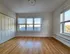 Bright and airy room with hardwood flooring, large windows, and ample natural light, perfect for creating a personalized living space.