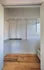 Spacious closet with versatile shelving and light wood flooring, perfect for organized storage.