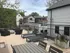 Inviting rooftop deck featuring modern lounge chairs, potted plants, and a cozy fire pit, perfect for outdoor relaxation.