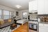 Cozy studio apartment showcasing a charming mix of modern kitchen amenities and a comfy living space with natural light.
