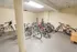 Secure indoor bike storage featuring multiple bicycles in a clean, well-lit space with rack and ample room for convenience.