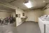 Spacious and practical laundry room with modern washing machines and a convenient bike storage area, offering efficiency and urban living comfort.