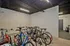 Modern indoor bike storage area with sleek lighting and ample space, perfect for urban living convenience.