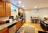 Charming kitchen with warm wooden cabinets, modern appliances, and cozy dining nook, perfect for culinary creativity and intimate meals.