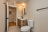 Modern bathroom featuring a sleek vanity with wood finish, elegant mirror, and stylish fixtures in a bright and welcoming space.