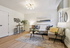 Modern living room with elegant decor, featuring a cozy sofa, chic coffee table, and contemporary lighting, perfect for relaxation and entertaining.