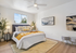 Bright and airy bedroom with modern decor featuring cozy bedding, stylish wall art, and elegant greenery.