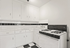 Charming retro-inspired kitchen with black and white checkered floor, classic cabinetry, and a vintage gas stove.