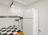 Bright and inviting kitchen with classic black and white checkered flooring, ample cabinet space, and modern appliances, perfect for culinary creativity.