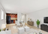 Bright and modern apartment living room with stylish decor, featuring a cozy open-plan design and elegant dining area next to a sleek kitchen.