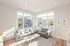 Bright and inviting living room with contemporary furniture, large windows, and abundant natural light.