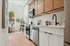 Sleek, modern kitchen with elegant cabinets, stainless steel appliances, and a large window offering natural light.